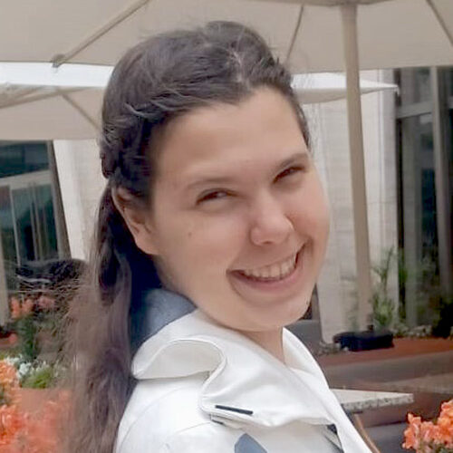 Mary Elizabeth Balof, a young woman with long dark hair, poses for a photo.