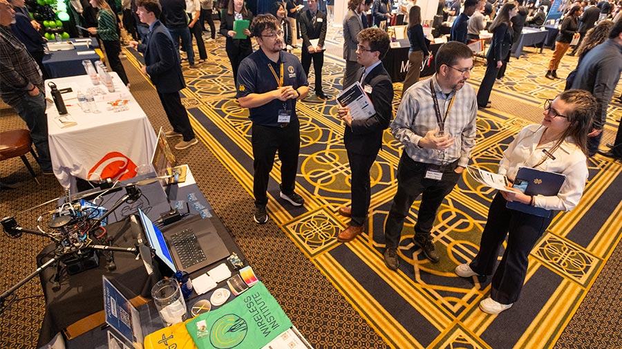 Overhead view of students and employers talking at booths during the Notre Dame Spring Career Fair.