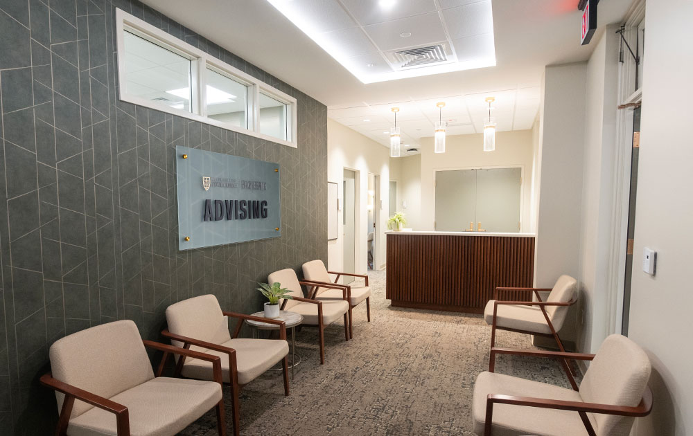 Newly renovated academic advising office with a reception desk and comfortable seating area.