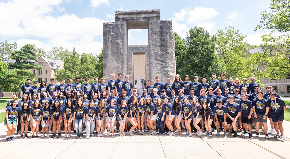Introduction to Engineering Program participants pose for a group photo on the Notre Dame campus in front of a fountain.
