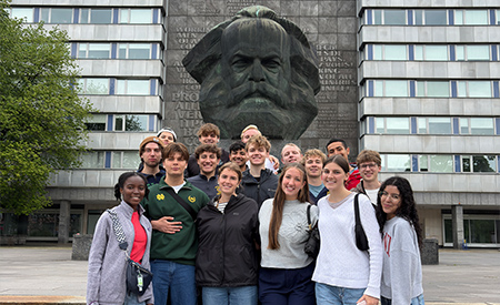 Engineering students pose for a group photo in front of a sculpture in Berlin.