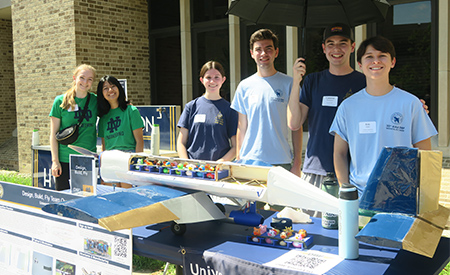 Student organization members showcase a project at the Welcome Weekend activities fair.