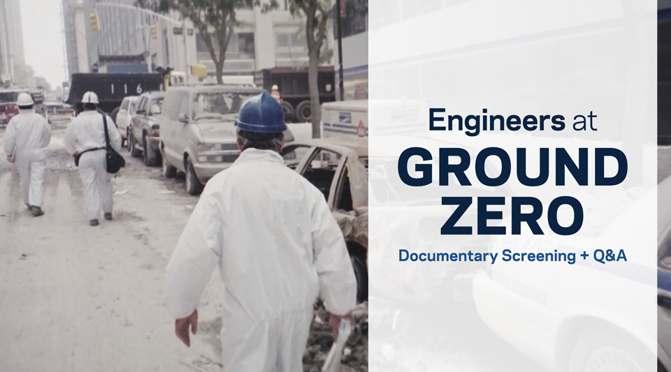 The image is a black and white photo of people walking toward Ground Zero wearing hard hats and protective suits.